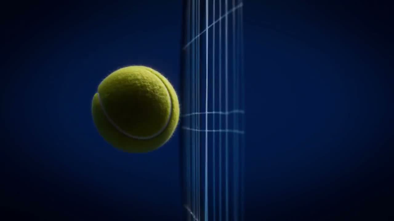Tennis ball meeting the strings, macro still frame